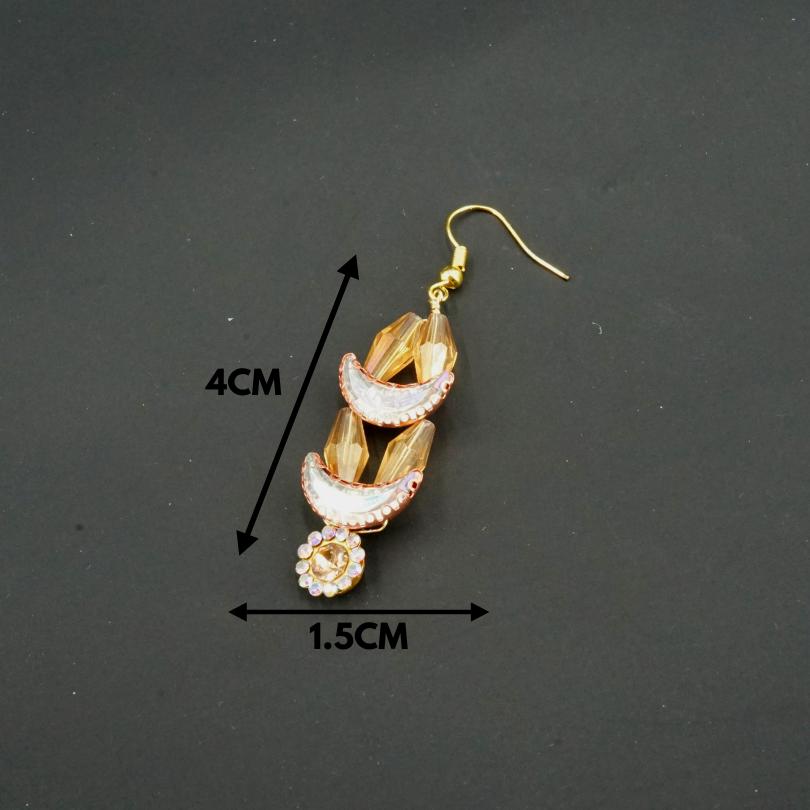 Gold-colored earrings, shaped like crescent moons and golden flowers in pearls