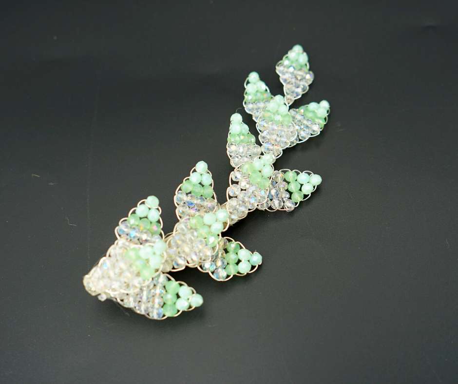 Green and white diamond-shaped brooch