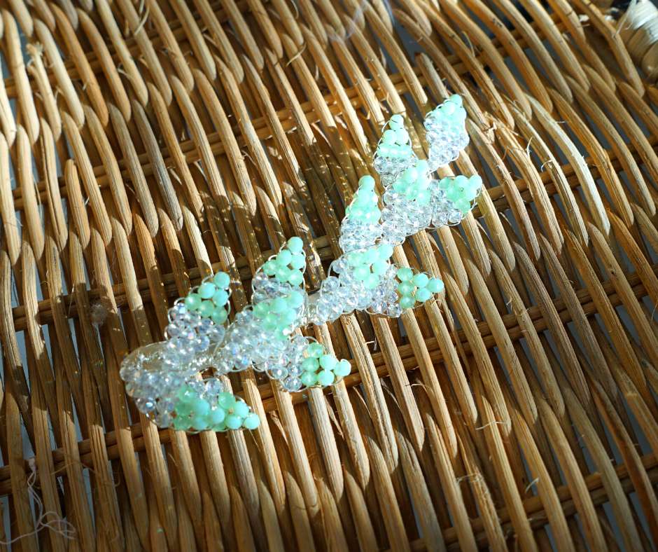 Green and white diamond-shaped brooch