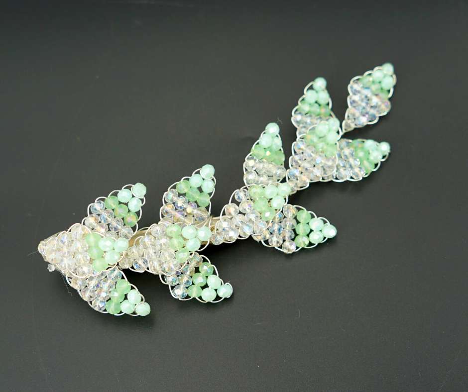 Green and white diamond-shaped brooch
