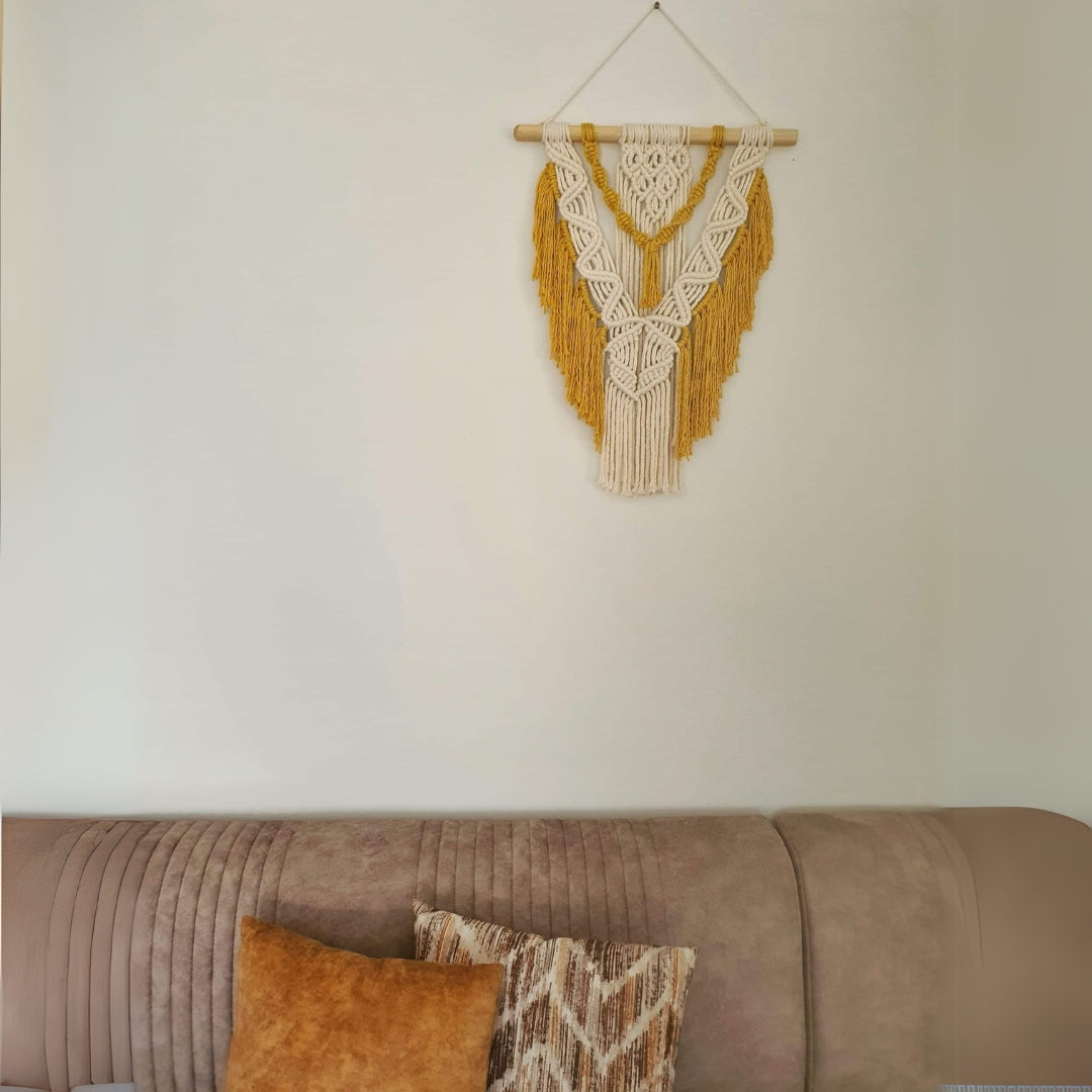Décoration suspendue en macramé blanc cassé et jaune avec un support en bois