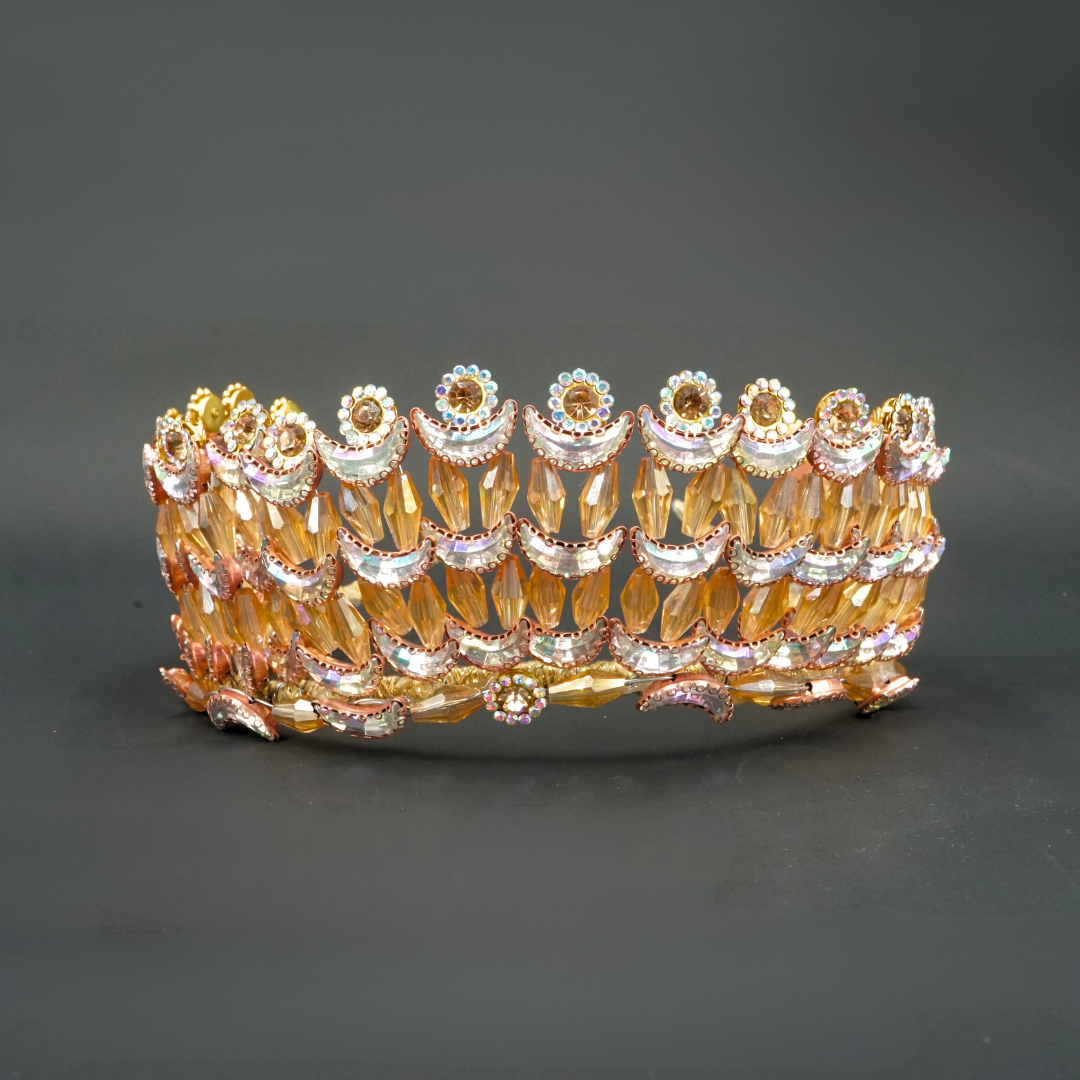 Gold-colored wedding crown modeled with crescent moons and golden flowers in pearls