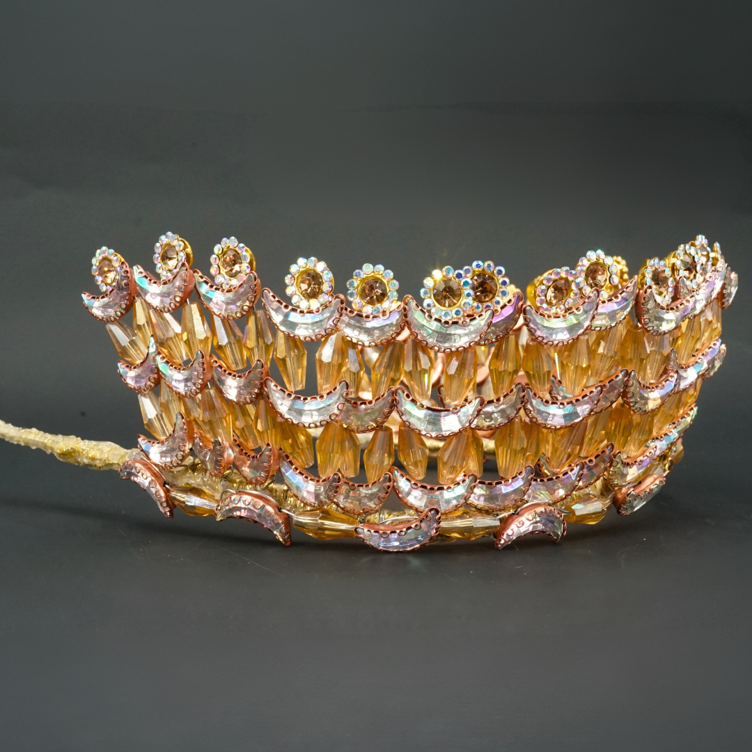 Gold-colored wedding crown modeled with crescent moons and golden flowers in pearls