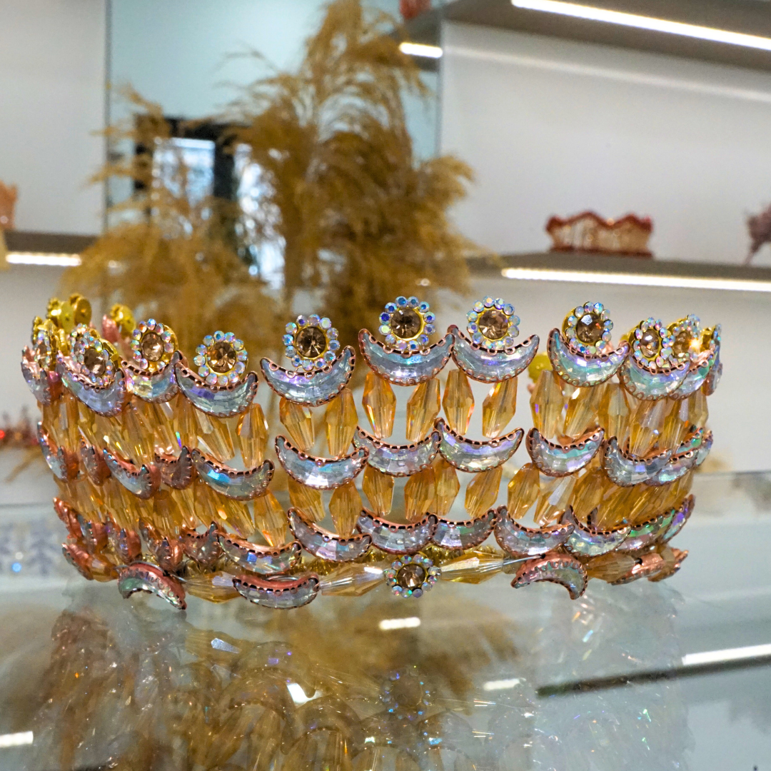 Gold-colored wedding crown modeled with crescent moons and golden flowers in pearls