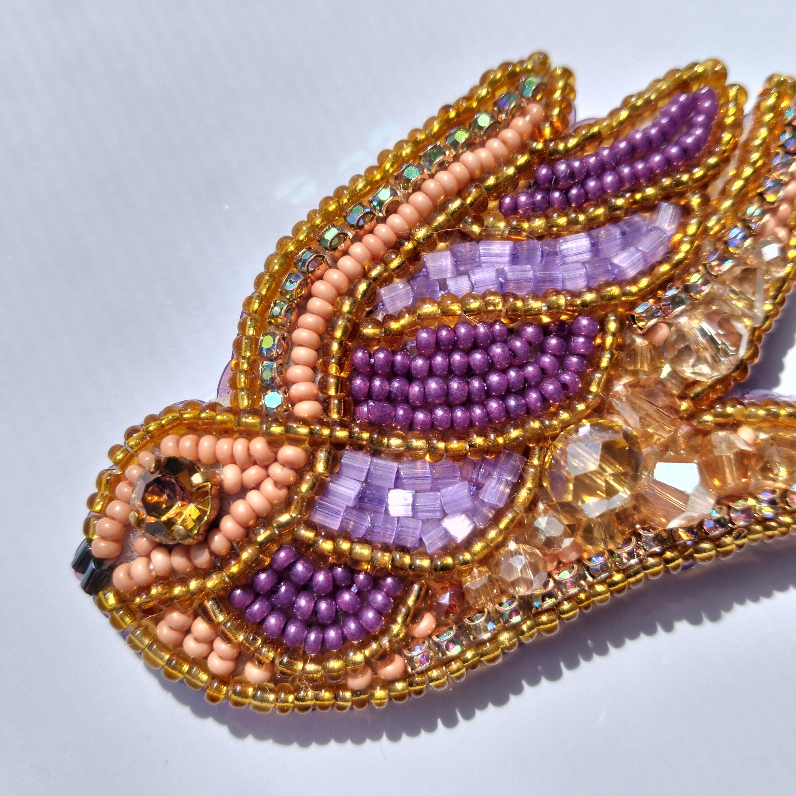 Hand-embroidered bird brooch with Preciosa crystals, bronze & purple