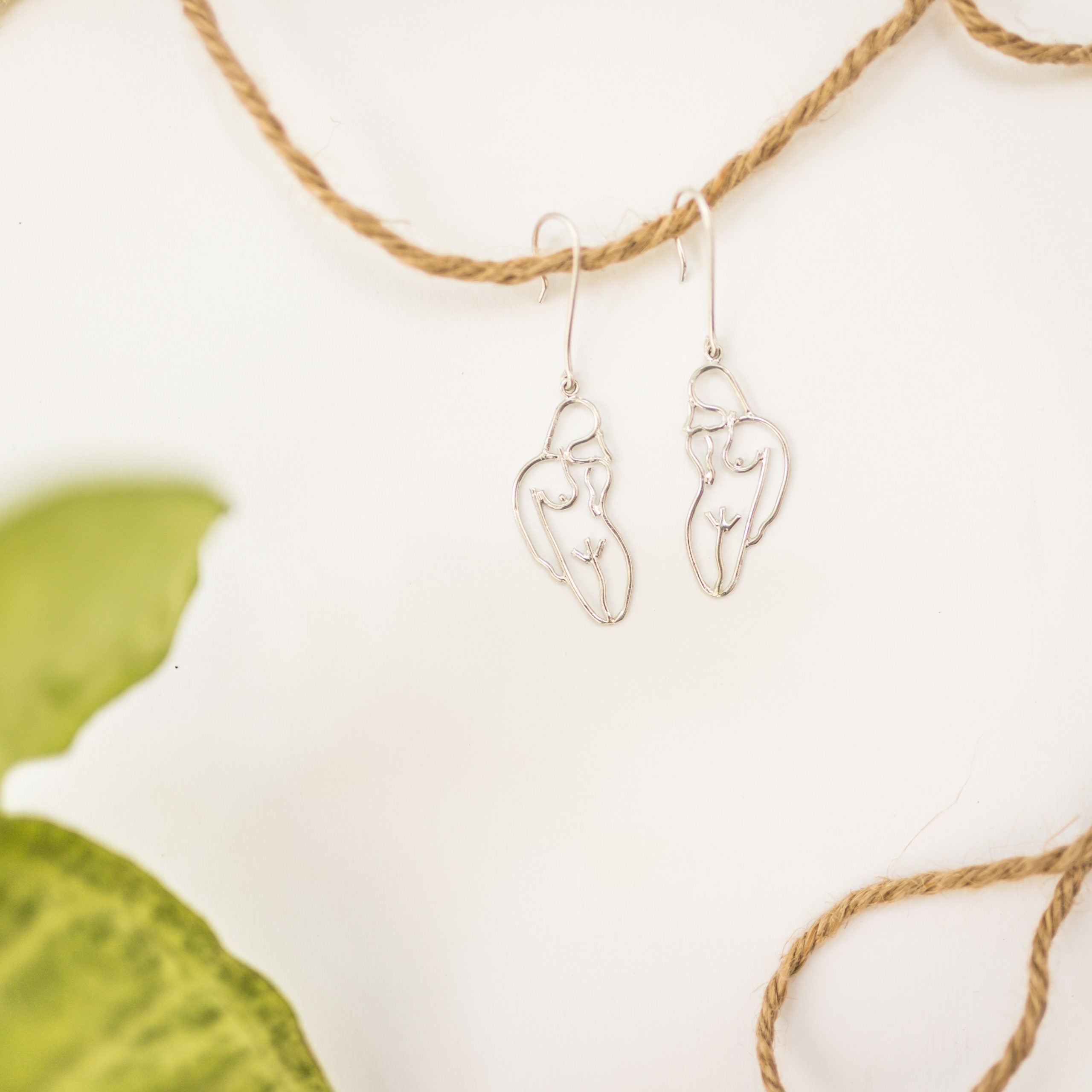 Small handmade female body earrings in 900 silver