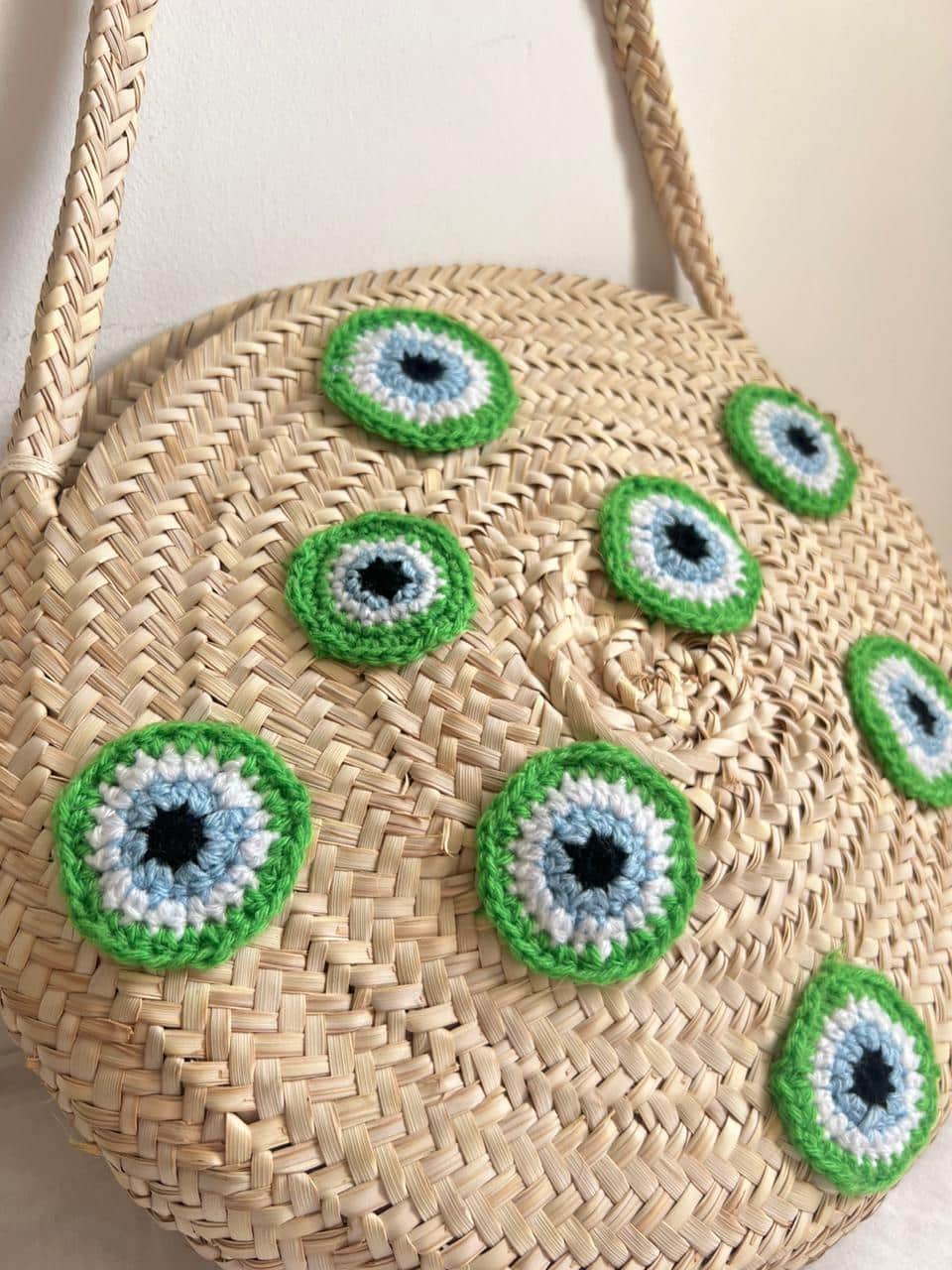 round basket with crocheted evil eyes