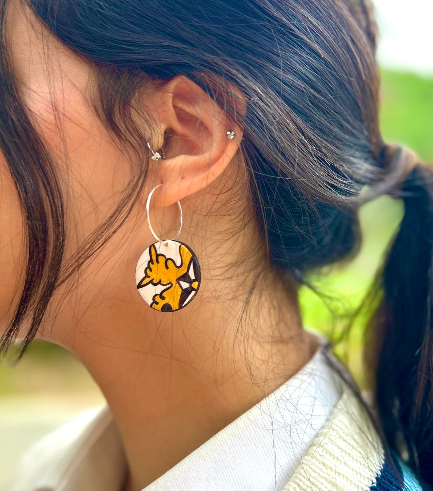Earrings inspired by a traditional handmade ceramic "Lion's Paw" motif, FIMO polymer clay bead and silver post