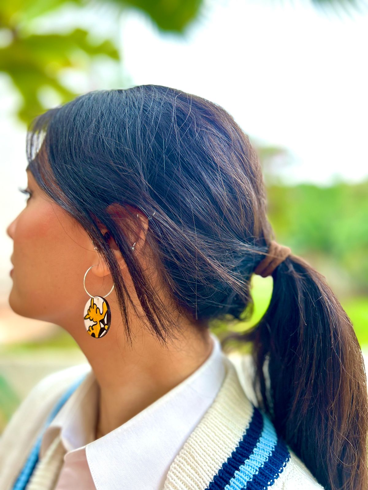 Earrings inspired by a traditional handmade ceramic "Lion's Paw" motif, FIMO polymer clay bead and silver post