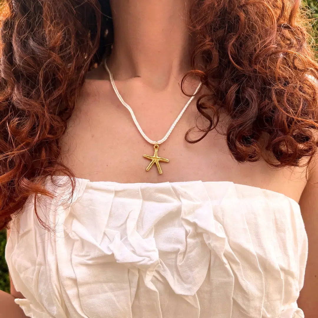 Bijou artisanal Tunisie — collier bohème étoile de mer dorée avec cordo. Fait main par des artisans.