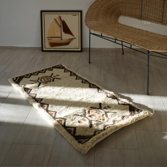 Berber rug with traditional border pattern